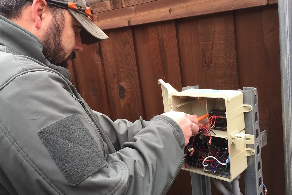 Lucent technician repairing pool automation controller wiring