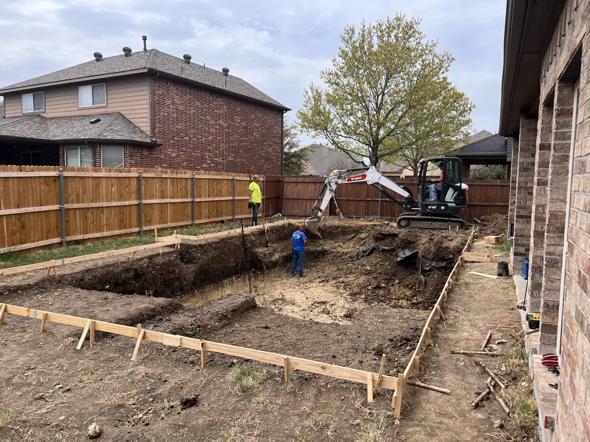 Excavator digging a pool shell during a Lucent pool build