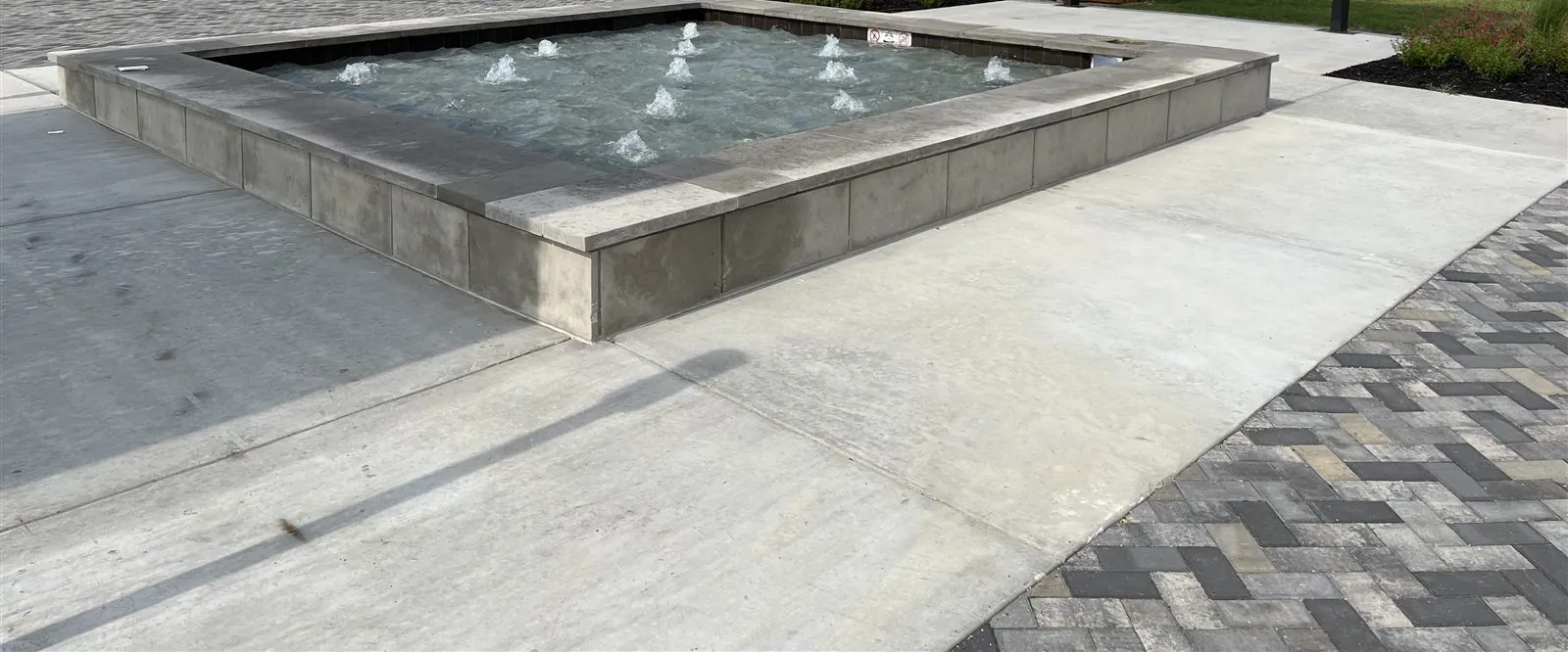 Water jets and basin of the Hollyhock center fountain in Frisco, TX