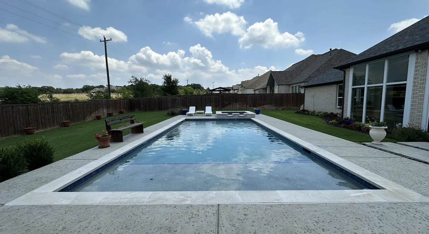 Crystal-clear water in a long rectangle pool with a clean deck.