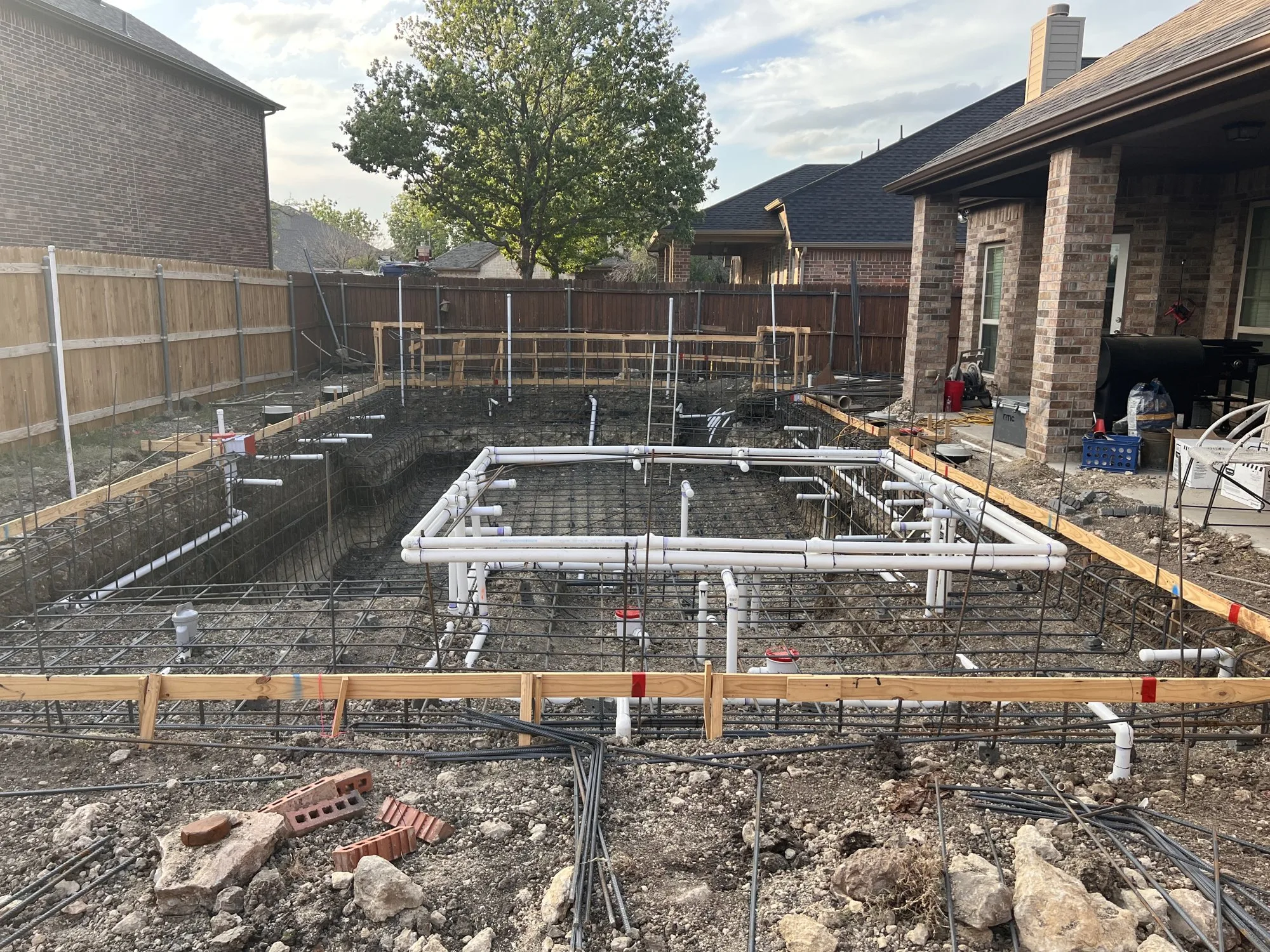 Steel rebar and plumbing pipes in a Lucent pool shell